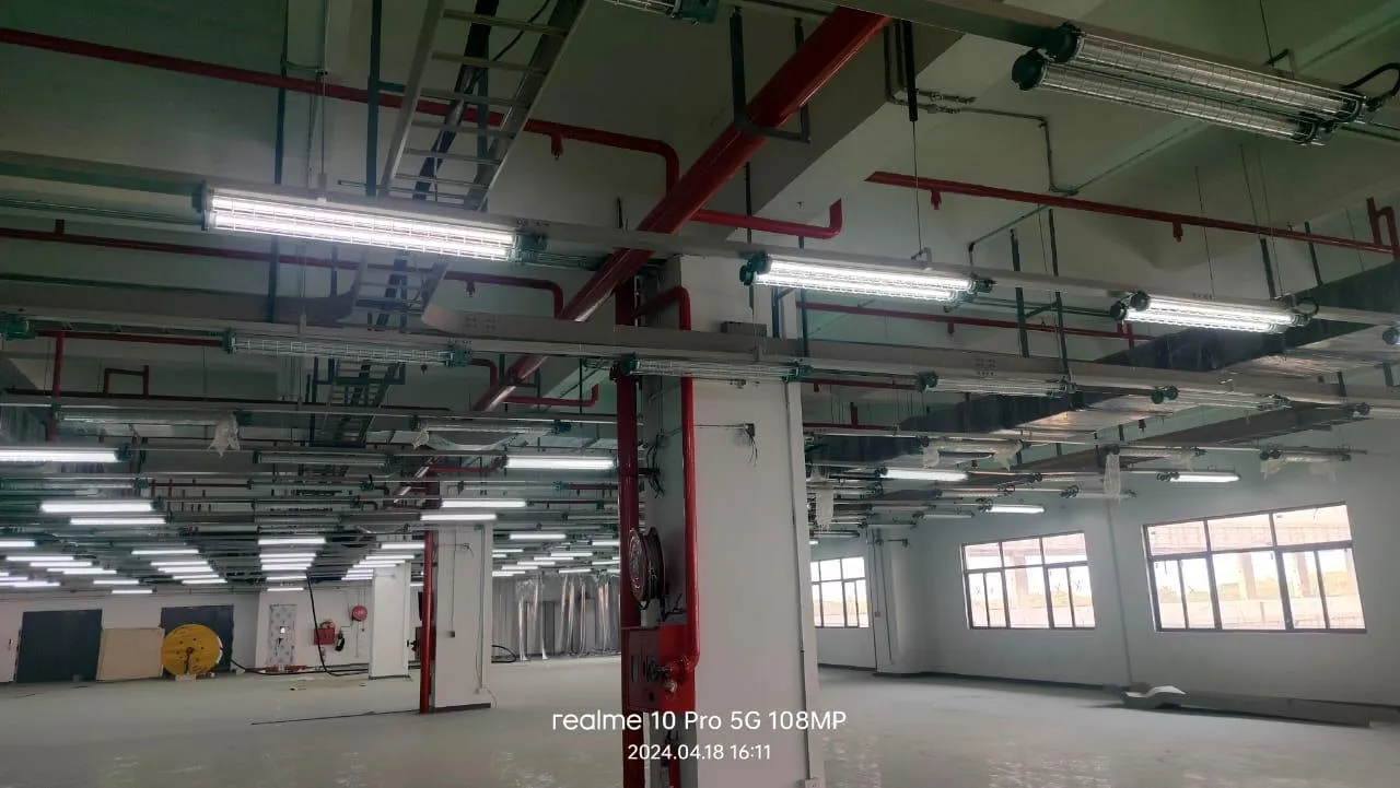 Hose cabinet on a column with sprinkler pipework overhead at Foxconn