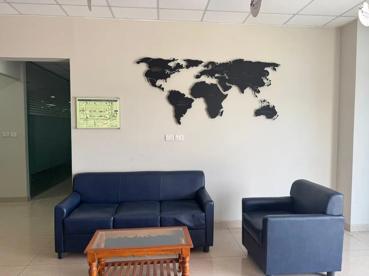 Lounge seating beneath a world map wall piece in the Kuibyshev Azot office block