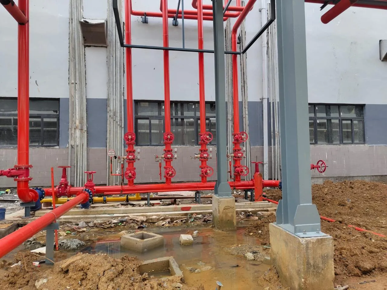 Riser standpipes and buried main under construction at the Foxconn building perimeter
