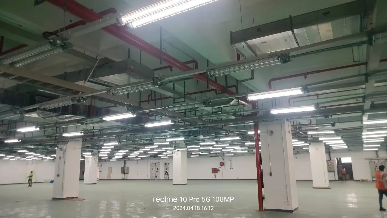 Sprinkler branch lines and hose cabinets across a Foxconn production floor