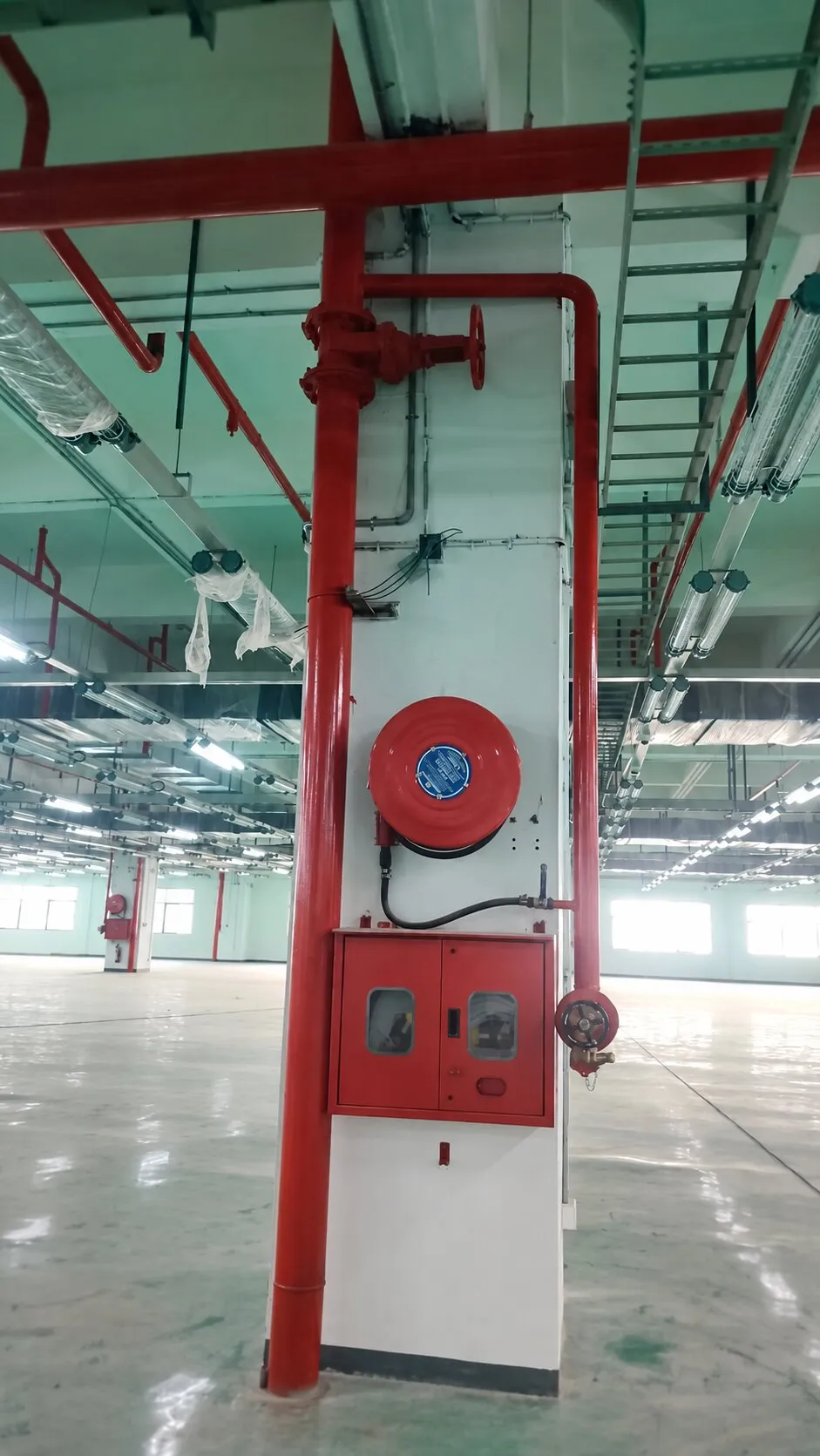 Wet riser, landing valve and hose reel at a column on a Foxconn production floor