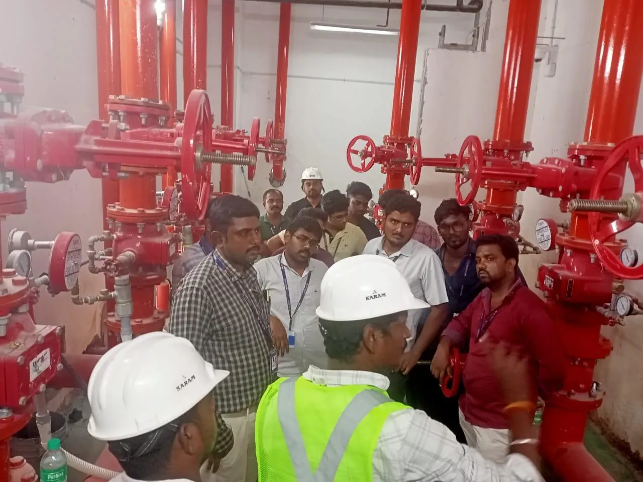 Site team in hard hats inspecting the riser valve set at Foxconn