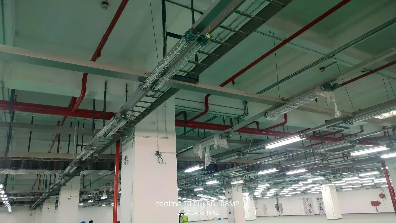 Sprinkler main routed alongside cable tray and services at Foxconn